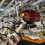 File photo: Robotic arms put in the electric vehicle powertrain into the Ariya model in the assembly line at Nissan's Tochigi plant in Kaminokawa town,  (AP)