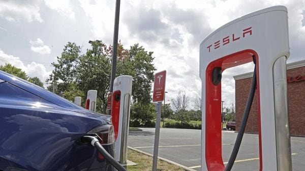 Tesla vehicle charges at a Tesla Supercharger site in Charlotte, N.C.