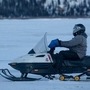 In a photo provided by the US Marine Corps, Sgt Jake Paolucci rides a snow machine across the Noatak River while traveling from Noatak to Kotzebue, in Alaska. (AP)