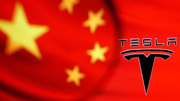FILE PHOTO: Chinese flag and Tesla logo seen through a magnifier in this illustration  (REUTERS)