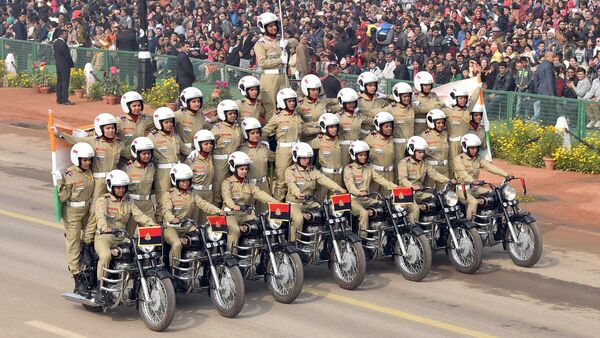 The image shows women bikers putting forth a splendid display of unity and grit via a motorcycle stunt. The image shows women bikers putting forth a splendid display of unity and grit via a motorcycle stunt.