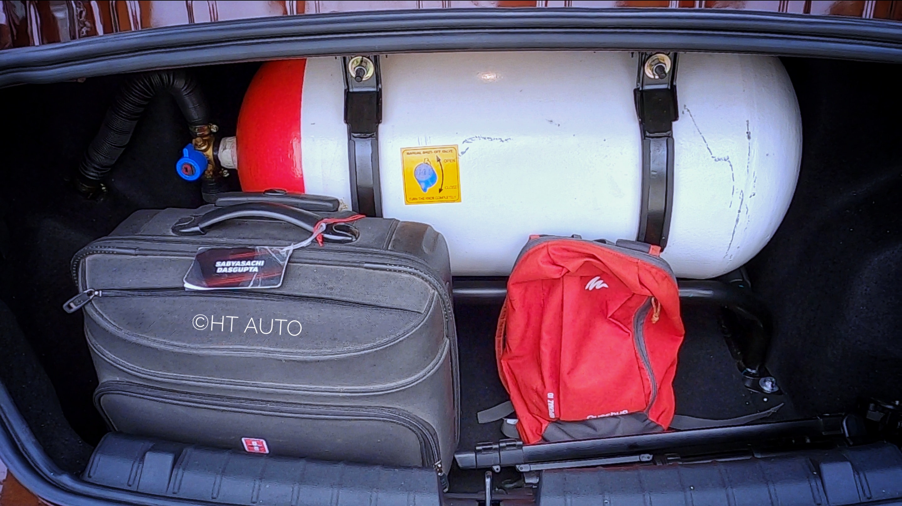 The addition of the CNG kit means the Tigor has lost some boot space. Without the cylinder, Tigor offers 419 litres of space. However, with the CNG kit, it offers only 205 litres. There is enough space to tuck in small luggages around the cylinder. Since the CNG kit is mounted higher than the boot's surface, it allows to slide through small items and utilise the space. (Photo: Sabyasachi Dasgupta/HT Auto) The addition of the CNG kit means the Tigor has lost some boot space. Without the cylinder, Tigor offers 419 litres of space. However, with the CNG kit, it offers only 205 litres. There is enough space to tuck in small luggages around the cylinder. Since the CNG kit is mounted higher than the boot's surface, it allows to slide through small items and utilise the space. (Photo: Sabyasachi Dasgupta/HT Auto)