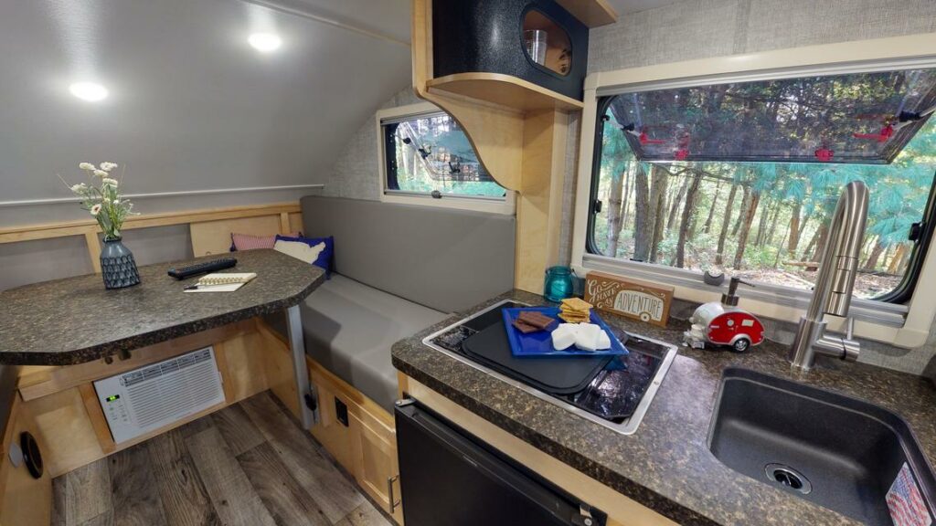 The Little Guy Trailer adds a lot of options for electronics, appliances, and plumbing, including an eight-inch deep stainless steel kitchen sink. The Little Guy Trailer adds a lot of options for electronics, appliances, and plumbing, including an eight-inch deep stainless steel kitchen sink.