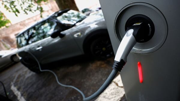 FILE PHOTO: An electric car is seen plugged in at a charging point for electric vehicles. (REUTERS)