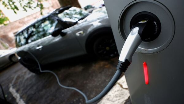 An electric car is seen plugged in at a charging point for electric vehicles. (File photo used for representational purpose only) (REUTERS)