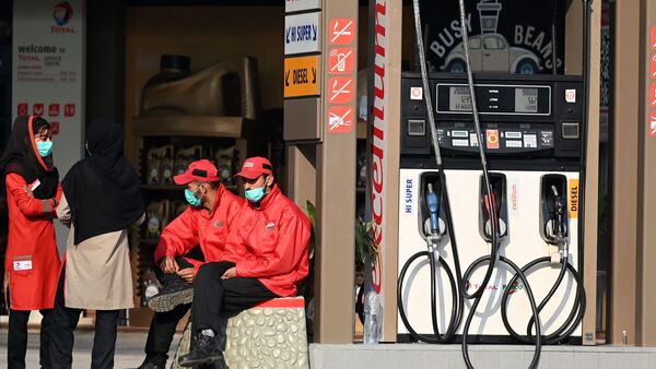 Employees at a fuel station wait for customers in Islamabad. (AFP)