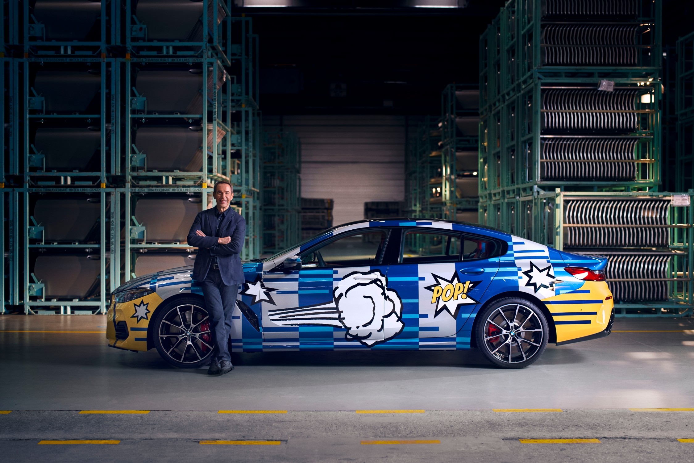 Jeff Koons posing with his special edition BMW 8 Series Coupe