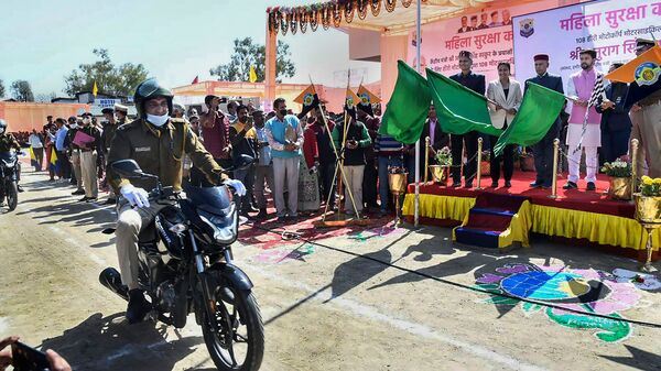 Union Minister for Information & Broadcasting Anurag Singh Thakur flags off the 108 motorcycles by Hero MotoCorp for police patrolling, during the 'Mahila Suraksha Kavach' programme, on the occasion of International Women's Day, in Hamirpur. (PTI)