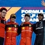 Ferrari racer Charles Leclerc celebrates on the podium after winning the Bahrain F1 race with teammate Carlos Sainz Jr. and third place going to Lewis Hamilton in his Mercedes. Also seen here is Ferrari team principal Mattia Binotto  (Left). (REUTERS)