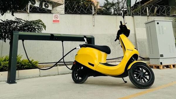 File photo of an Ola Electric scooter being charged at its Hypercharger network. (@bhash/Twitter)