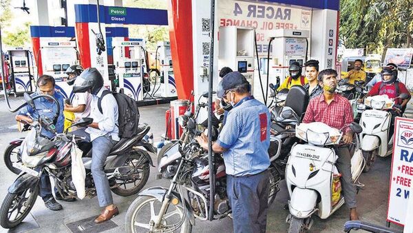 Motorcyclists wait in line to fill up at a gas station.  (Avatar)