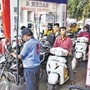 Motorcyclists wait in queues to get their vehicles filled with fuel, at a petrol pump. (Image used for representational purpose only) (HT_PRINT)