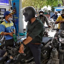 File photo: Motorists wait to get a tankful of petrol at a fuel station.