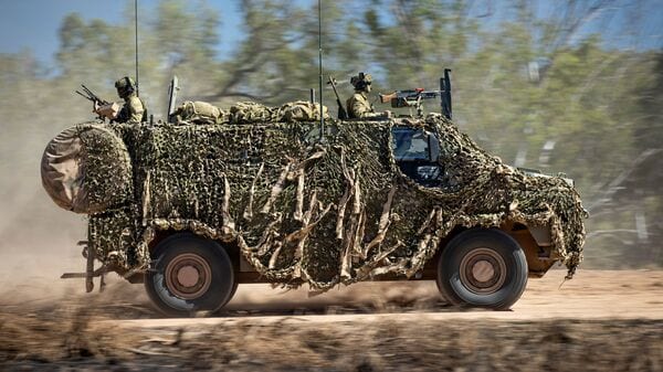 In this file photo provided by the Australian Defense Force, an Australian Army Bushmaster armored vehicle moves off road during a training mission. (AP)