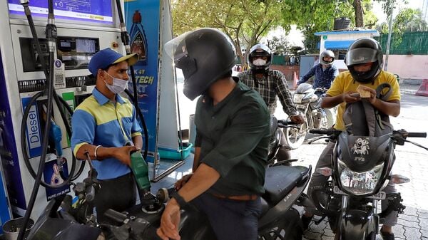 A petrol pump staff refills fuel in a two-wheeler in New Delhi. (ANI)