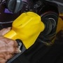File photo of a fuel-station attendant pumping petrol inside a vehicle. (AFP)