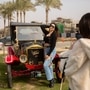 Classic cars enthusiast Carine Sherif poses in front of a 1924 Ford T owned by Egyptian collector Mohamed Wahdan during a classic car show in Cairo, Egypt, (AP)