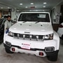 An employee cleans an imported vehicle at a car showroom in Islamabad. (AFP)
