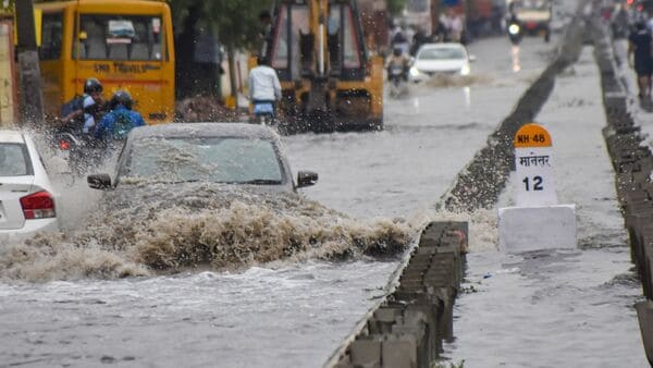 Vehicles wade through the waterlogged service road of the Delhi-Gurugram expressway after heavy rains, in Gurugram.