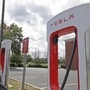 File photo of a Tesla vehicle being charged at a Supercharger