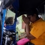 Lasanda Deepthi, 43, an auto-rickshaw driver for local ride hailing app PickMe, prays in front of the Lord Buddha idol inside her auto-rickshaw before going to work in Gonapola town, on the outskirts of Colombo. (REUTERS)