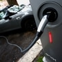 FILE PHOTO: An electric car is seen plugged in at a charging point for electric vehicles. (REUTERS)
