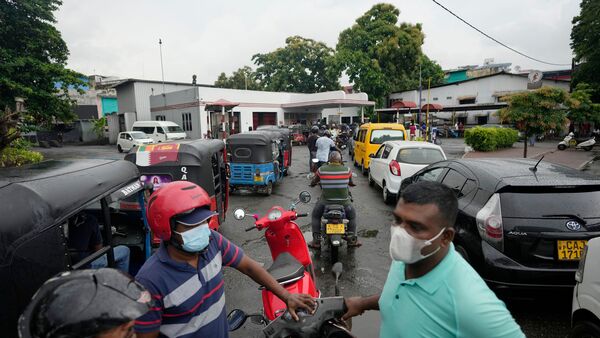 File photo: People wait in a long queues to buy fuel for their vehicles at a filling station in Colombo, Sri Lanka. (AP)