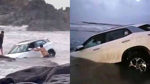 The SUV can be seen stuck in sand on the Goa beach. 