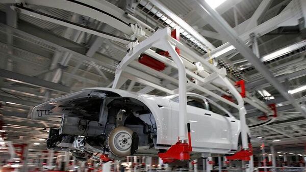 File photo: The body of a Tesla Model S is transported by an automated crane at the Tesla factory in Fremont, California. (REUTERS)