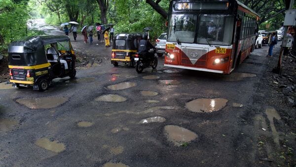 Motorists navigate potholes resurfaced on Aarey Dairy road due to heavy rainfall in Mumbai. (Photo by Vijay Bate/HT Photo) (HT PHOTO)