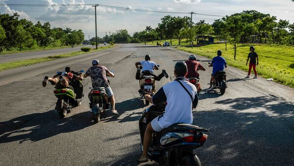 People take off for a race on their electric scooters as they gather for a late afternoon showing off of stunts and racing in Havana, Cuba,. (AP)