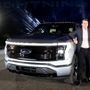 Ford CEO Jim Farley poses with the all-electric Ford F-150 Lightning pickup truck. (File Photo) (REUTERS)