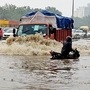 File photo of vehicles moving through waterlogged road after incessant rainfall at Delhi-Jaipur highway last month. (ANI)
