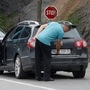 A driver removes a sticker covering the national markings on his car plates at the Jarinje border crossing in Kosovo. (File Photo) (REUTERS)