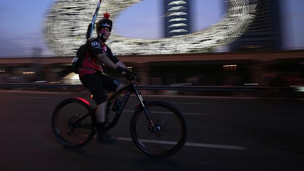 Another bicyclist rides past the Museum of the Future, in Dubai, United Arab Emirates, Another bicyclist rides past the Museum of the Future, in Dubai, United Arab Emirates,