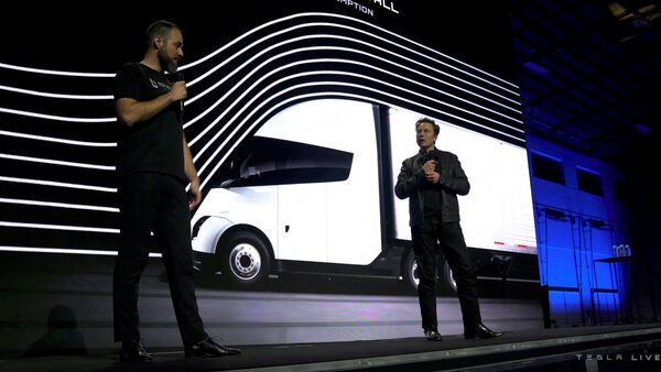 Tesla CEO Elon Musk talks to Dan Priestly, Senior Director of Tesla Semi Truck Engineering, during the live-streamed launch of the Tesla Semi electric truck, in Nevada, U.S. on December 1, 2022 , in this still image taken from the video.  Tesla/Handout via REUTERS THIS IMAGE IS SUPPLIED A THIRD PARTY.  NO SALE.  NO STORAGE