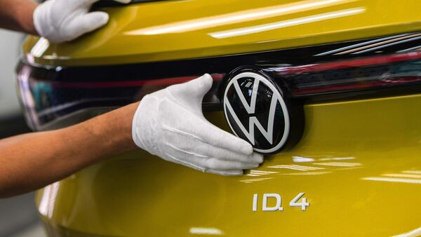 An employee performs a final quality check on a Volkswagen ID.4 SUV at its EV factory in Zwickau, Germany.  (Bloomberg)