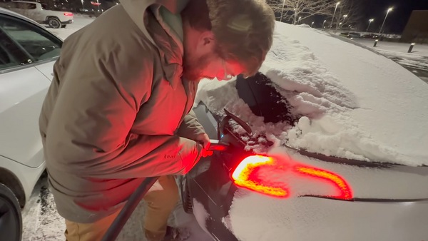 This Tesla Model 3 owner braved minus 25 degrees to recharge his electric car at a public charging station in the United States.  (Image credit: YouTube/Out Of Spec Reviews)