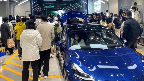 People protest in front of a Tesla showroom in Chengdu, Sichuan, China.  (via Reuters)