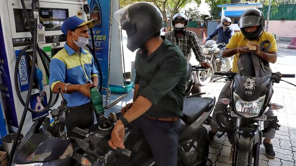 A gas station attendant refuels a two-wheeler in New Delhi.  (ANI)
