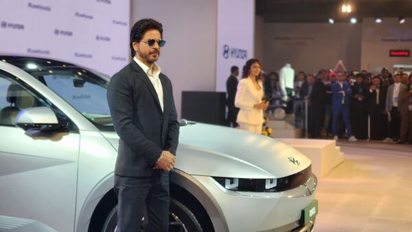 Shah Rukh Khan stands next to the Ioniq 5 EV at the Hyundai Pavilion at Auto Expo 2023.