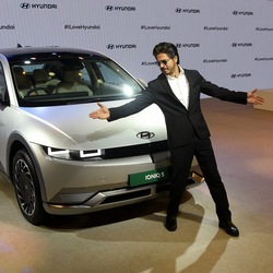 Bollywood showman Shah Rukh Khan in his iconic pose in front of Hyundai's showstopper Ioniq 5 at the Auto Expo 2023.