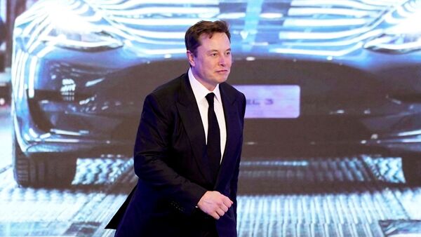 Tesla CEO Elon Musk walks next to a screen showing an image of Tesla Model 3 car during an opening ceremony for Tesla China-made Model Y program in Shanghai, (File Photo) (REUTERS)