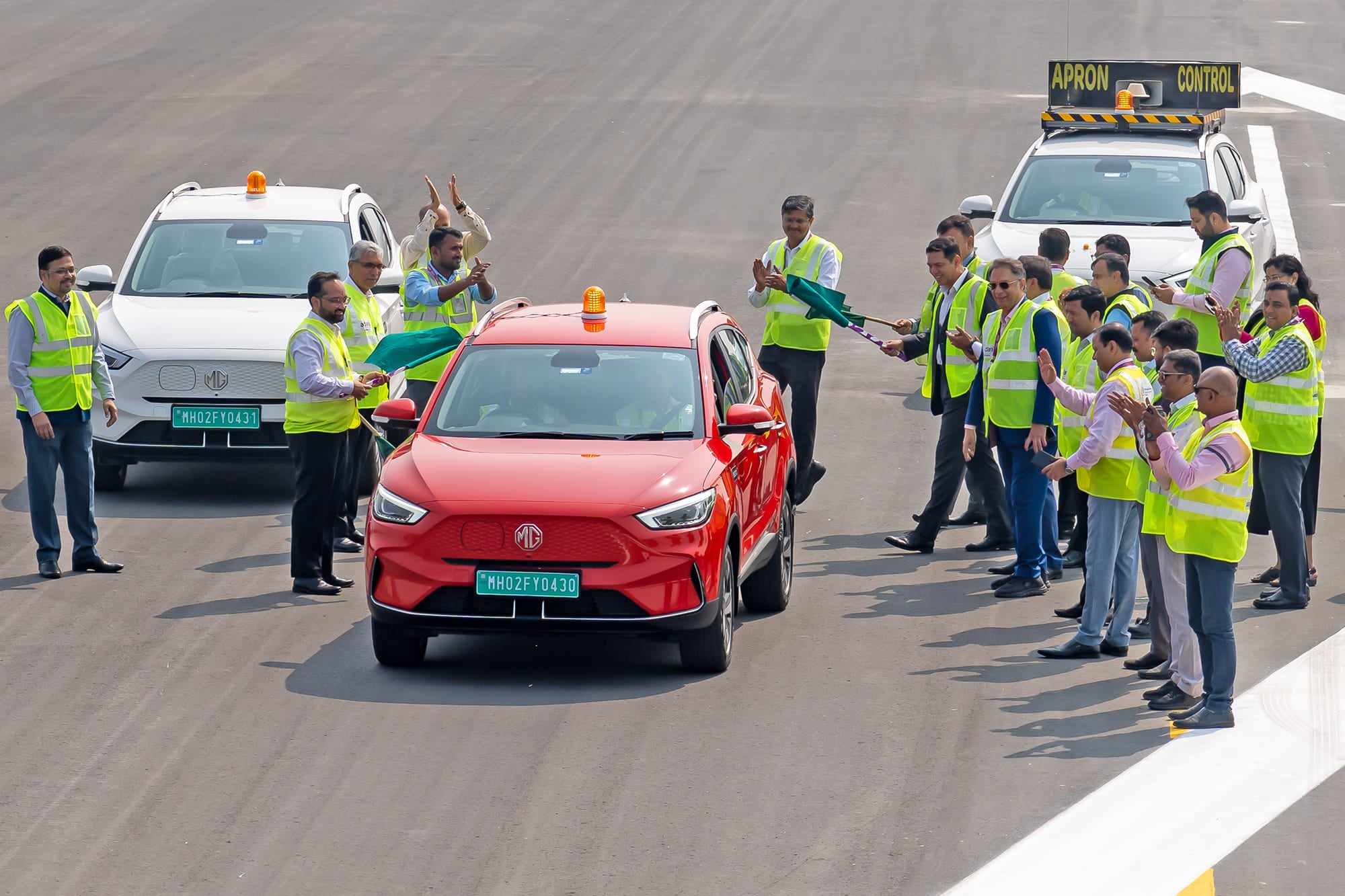 Ground staff at Mumbai International Airport fly the flag for the MG ZS EV airside