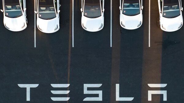 (FILE) In this Feb. 10, 2022, file photo, an aerial view shows cars parked at Tesla's Fremont factory in Fremont, California.  - Tesla reports another round of record quarterly profits on Jan. 25, 2023, while confirming its long-term production outlook despite concerns about increased competition and macroeconomic headwinds.  (Photo by Josh Edelson/AFP) (AFP)