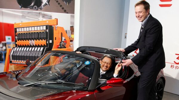File photo of Toyota Motor's outgoing President Akio Toyoda presented with the keys to a Tesla Roadster electric car by Elon Musk . (REUTERS)
