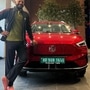 Murali Kartik shared an image posing with his new MG ZS EV in the red shade (Instagram/Murali Kartik)