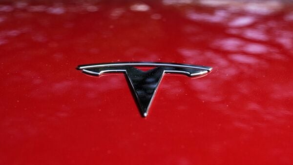 FILE PHOTO: The Tesla logo is seen on a vehicle on display in Austin, Texas.  (Associated Press)