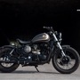 The motorcycle is finished in a dark metallic silver with a matte finish. There is a touch of gold leaf to enhance the curves of the bike.