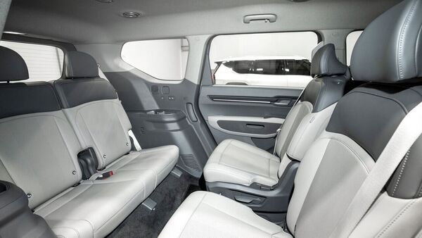 The EV9 is a three row SUV. The second row can be swiveled 180-degrees so that the occupants can interact with those sitting in the third row. The third-row seats also offer cup holders and charging points for mobile devices. The EV9 is a three row SUV. The second row can be swiveled 180-degrees so that the occupants can interact with those sitting in the third row. The third-row seats also offer cup holders and charging points for mobile devices.